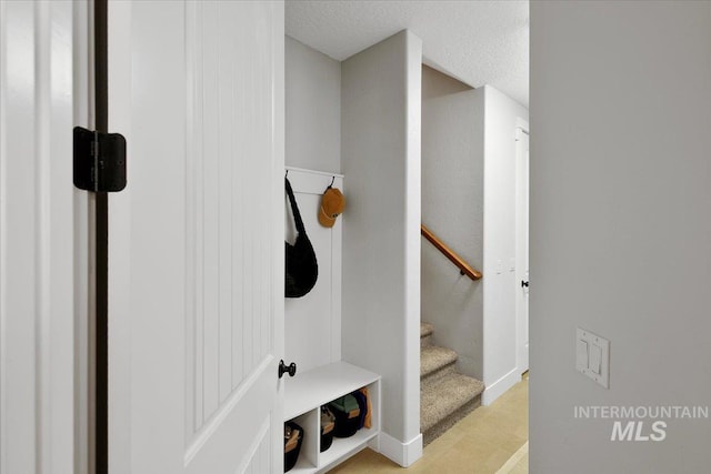 mudroom with a textured ceiling