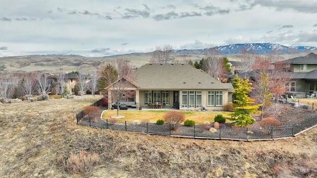 back of property featuring an outdoor hangout area, a patio, fence private yard, and a mountain view