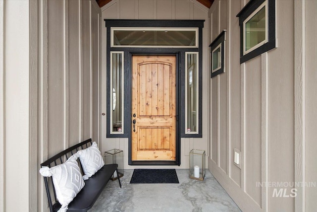 doorway to property featuring board and batten siding