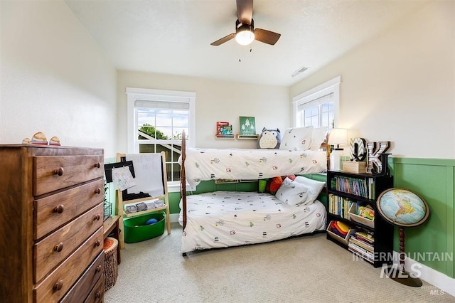 bedroom with a ceiling fan, carpet, and visible vents