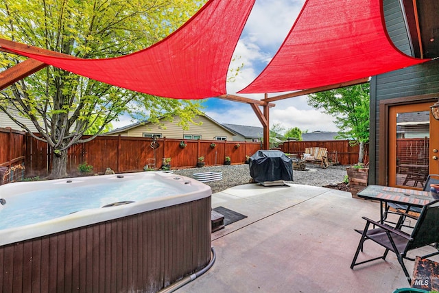 view of patio / terrace featuring area for grilling, a fenced backyard, and a hot tub