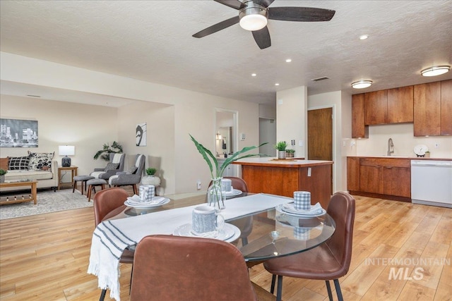 1134 N Camelot Dr, Boise, ID 83704 - dining room with light wood-style floors, a ceiling fan, a textured ceiling, and recessed lighting