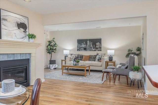1134 N Camelot Dr, Boise, ID 83704 - living area with light wood finished floors and a fireplace