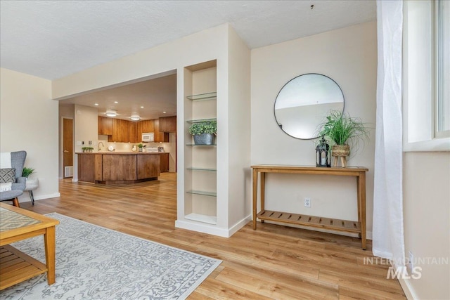 1134 N Camelot Dr, Boise, ID 83704 - living room with built in features and light wood-style flooring