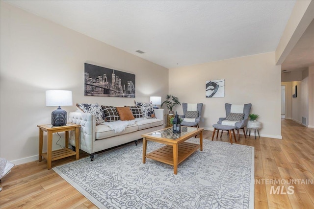 1134 N Camelot Dr, Boise, ID 83704 - living room featuring light wood-type flooring and baseboards