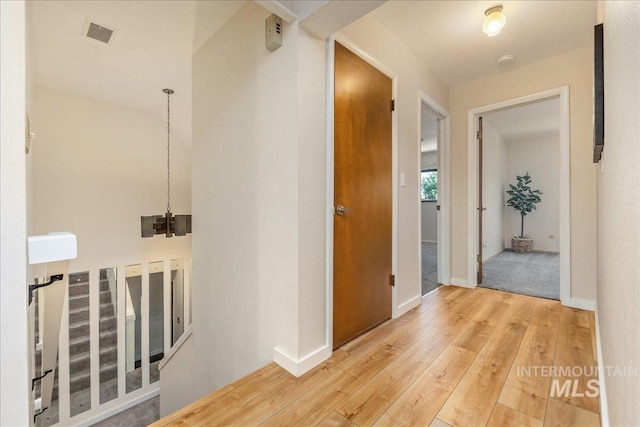 1134 N Camelot Dr, Boise, ID 83704 - hallway featuring hardwood / wood-style flooring and a chandelier