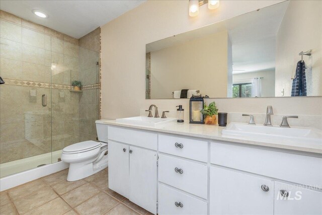 1134 N Camelot Dr, Boise, ID 83704 - full bath with double vanity, a shower stall, and tile patterned flooring