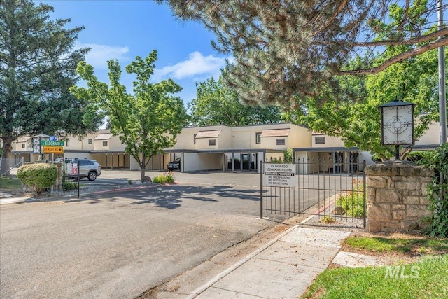 1134 N Camelot Dr, Boise, ID 83704 - townhome / multi-family property with a gate, stucco siding, and parking