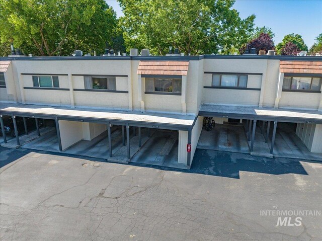 1134 N Camelot Dr, Boise, ID 83704 - view of front of property with covered parking and stucco siding
