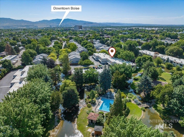 1134 N Camelot Dr, Boise, ID 83704 - aerial view of property's location featuring a pool and a mountainous background