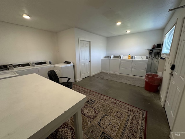 shared laundry area with baseboards and washer and dryer