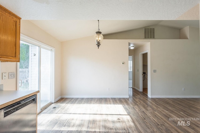 4709 Pioneer Ave, Caldwell, ID 83607 - unfurnished dining area with light wood-style flooring, lofted ceiling, baseboards, and a textured ceiling