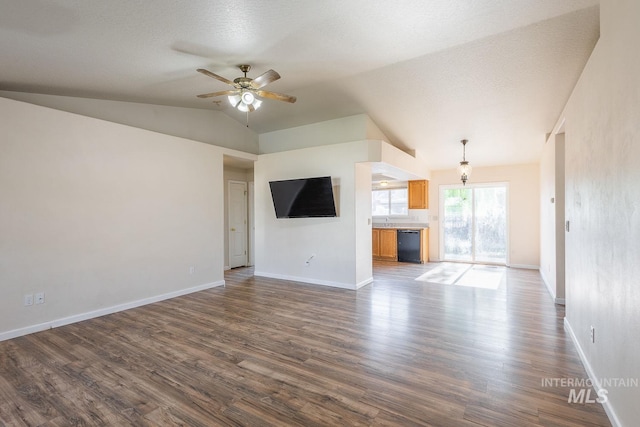 4709 Pioneer Ave, Caldwell, ID 83607 - unfurnished living room featuring dark wood-type flooring, a ceiling fan, lofted ceiling, and baseboards