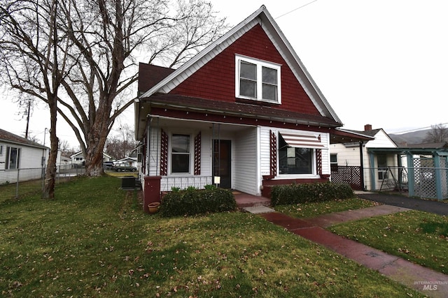 view of front of home featuring a porch, a front lawn, and fence