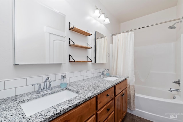 full bath featuring backsplash, double vanity, shower / bath combo with shower curtain, and a sink