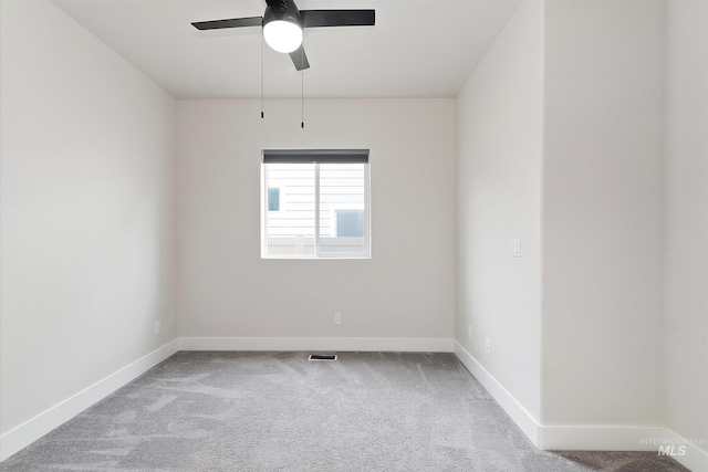 unfurnished room with visible vents, baseboards, carpet floors, and ceiling fan