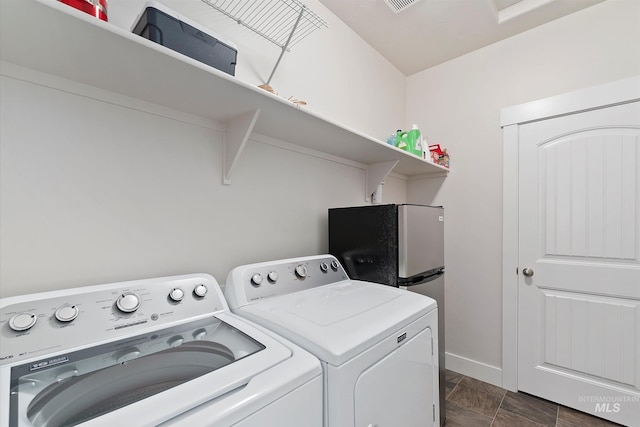 laundry room with washing machine and dryer, baseboards, visible vents, and laundry area