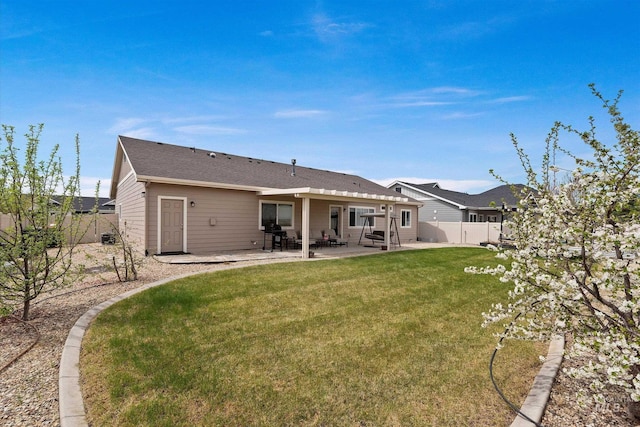 back of house featuring a yard, a patio area, and a fenced backyard