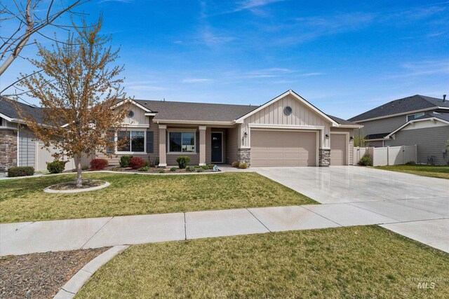 ranch-style house featuring concrete driveway, fence, a garage, board and batten siding, and a front yard