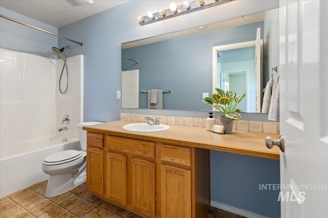 full bathroom with toilet, a textured ceiling, vanity, and shower / bath combination