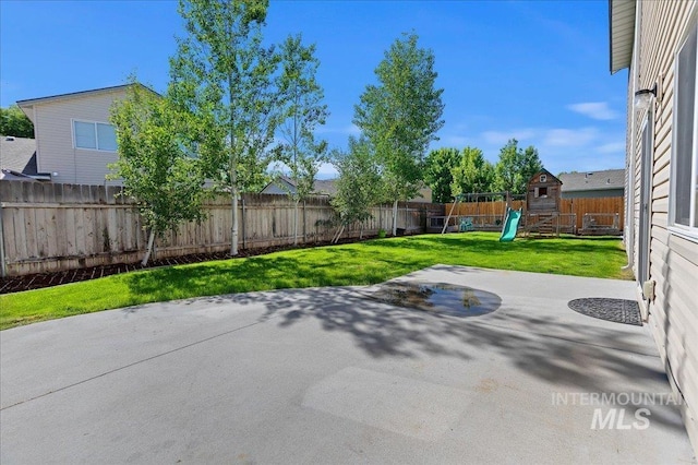 view of patio featuring a fenced backyard and a playground