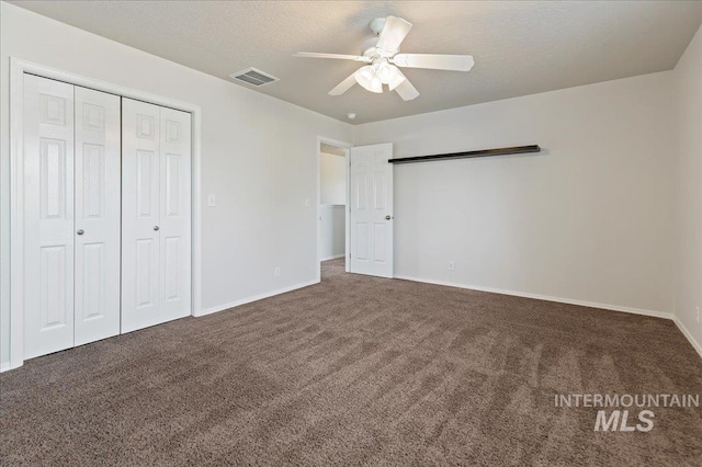 unfurnished bedroom featuring carpet flooring, baseboards, visible vents, and a closet