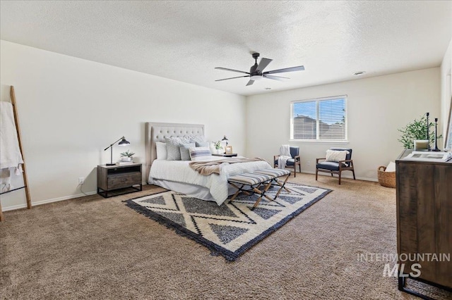 bedroom featuring carpet, baseboards, and a textured ceiling