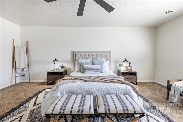 carpeted bedroom featuring visible vents, baseboards, a textured ceiling, and a ceiling fan