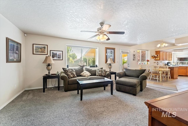 3012 Myrtlewood Way, Nampa, ID 83686 - living room with a textured ceiling, light carpet, ceiling fan, a chandelier, and baseboards