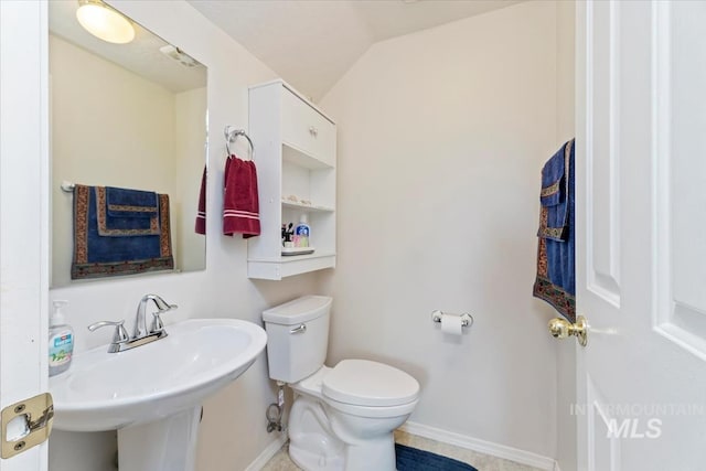3012 Myrtlewood Way, Nampa, ID 83686 - half bathroom with baseboards, toilet, vaulted ceiling, and a sink