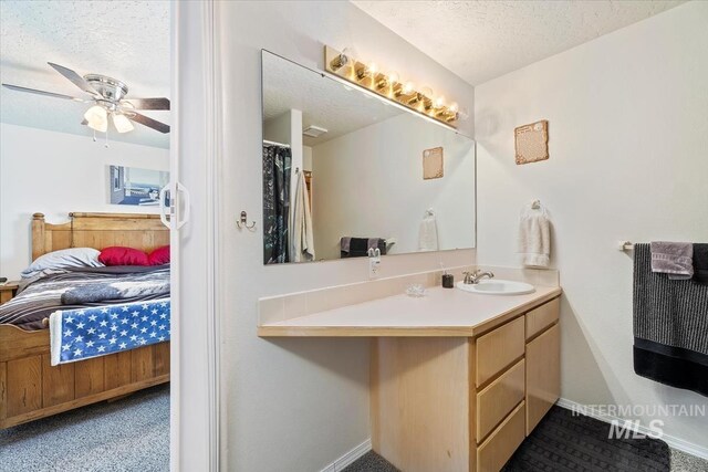 3012 Myrtlewood Way, Nampa, ID 83686 - ensuite bathroom with a textured ceiling, vanity, ceiling fan, and baseboards