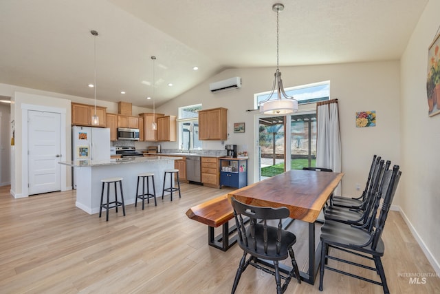 8142 US Highway 95, Marsing, ID 83639 - dining room with a wall mounted air conditioner, light wood-type flooring, baseboards, and high vaulted ceiling