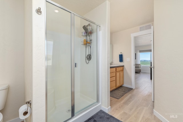 8142 US Highway 95, Marsing, ID 83639 - full bath with wood finished floors, toilet, a shower stall, vanity, and baseboards