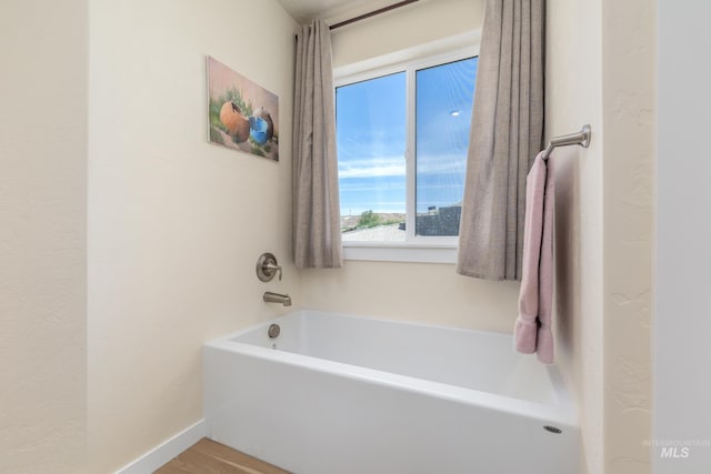 8142 US Highway 95, Marsing, ID 83639 - bathroom featuring a garden tub and wood finished floors