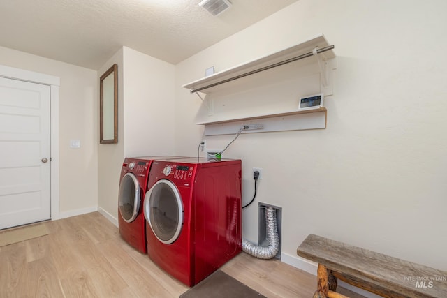 8142 US Highway 95, Marsing, ID 83639 - washroom featuring wood finished floors, baseboards, and separate washer and dryer