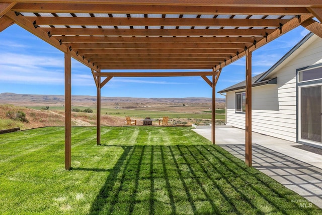 8142 US Highway 95, Marsing, ID 83639 - view of grassy yard with a pergola, a patio, a mountain view, and a view of countryside