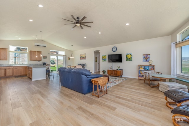 8142 US Highway 95, Marsing, ID 83639 - living area with vaulted ceiling, ceiling fan, light wood-style flooring, a wall unit AC, and recessed lighting