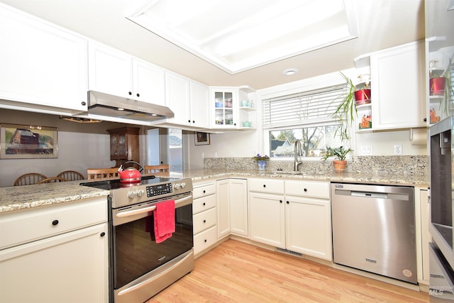 kitchen featuring light stone countertops, appliances with stainless steel finishes, sink, and white cabinets