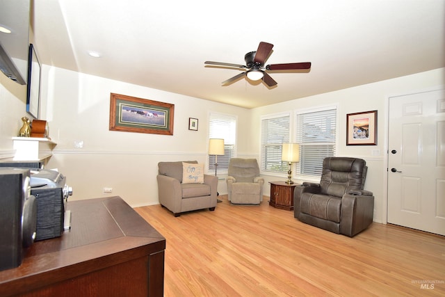 living room with ceiling fan and light wood-type flooring