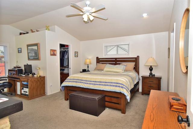 carpeted bedroom featuring multiple windows, a walk in closet, ceiling fan, and a closet