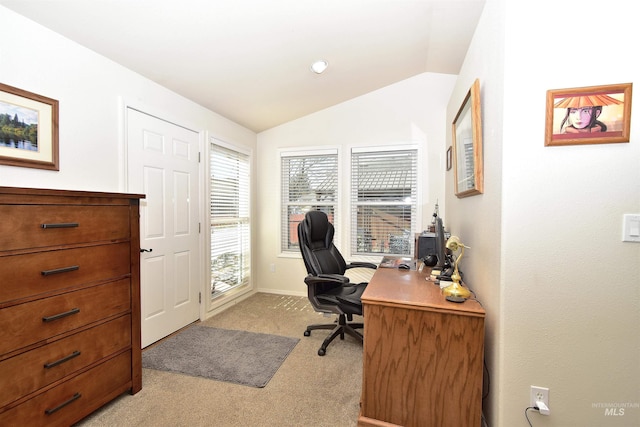 office area with lofted ceiling and light colored carpet