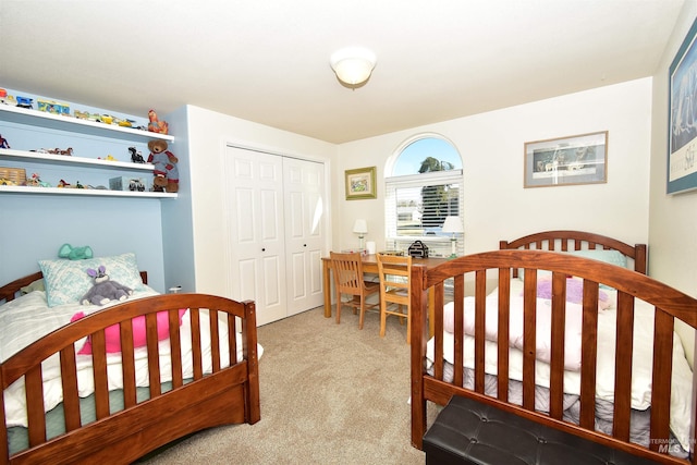 bedroom with light colored carpet and a closet