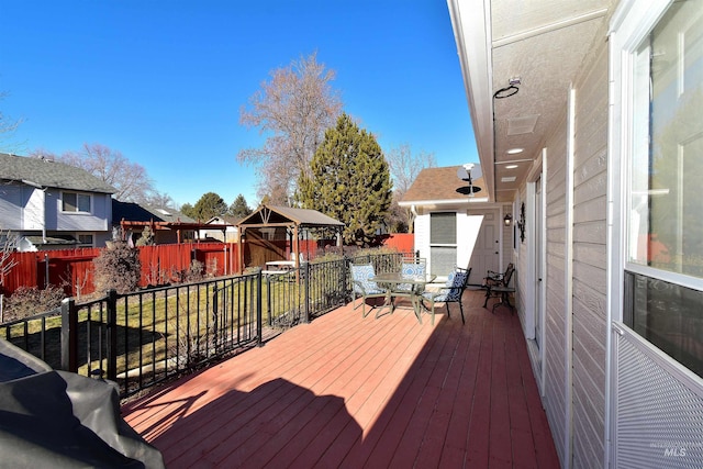 deck featuring a gazebo and a lawn