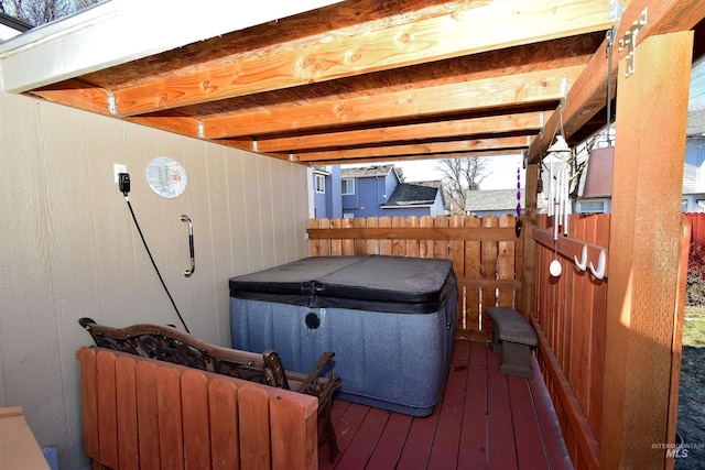 wooden deck with a hot tub