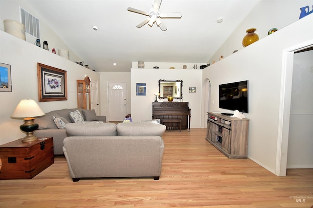 living room featuring ceiling fan, lofted ceiling, and light hardwood / wood-style floors