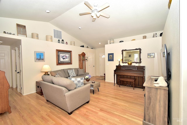 living room featuring ceiling fan, lofted ceiling, and light wood-type flooring