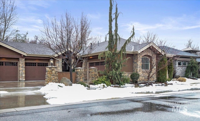 view of front facade featuring a garage and stone siding