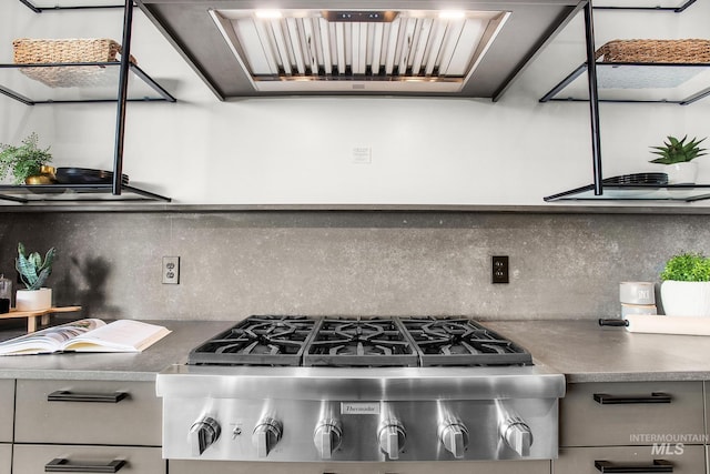 kitchen with backsplash and stainless steel gas stovetop