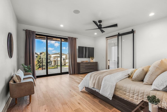 bedroom featuring access to outside, a barn door, ceiling fan, and light wood-type flooring