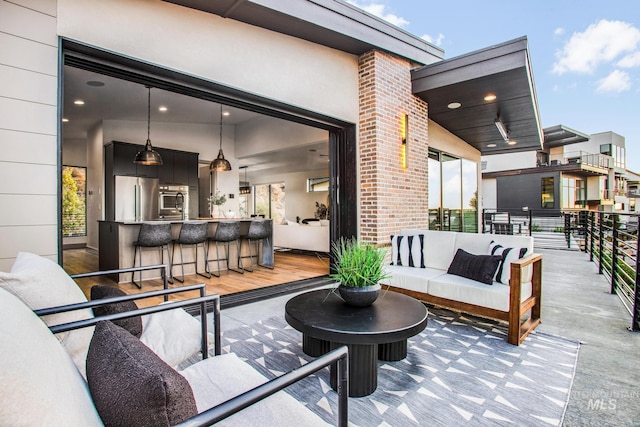 view of patio / terrace with outdoor lounge area and a bar